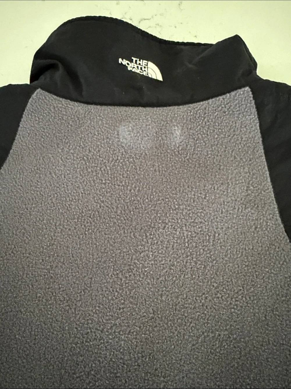 The North Face Black Shell with Gray Fleece-Lined Men's Vest